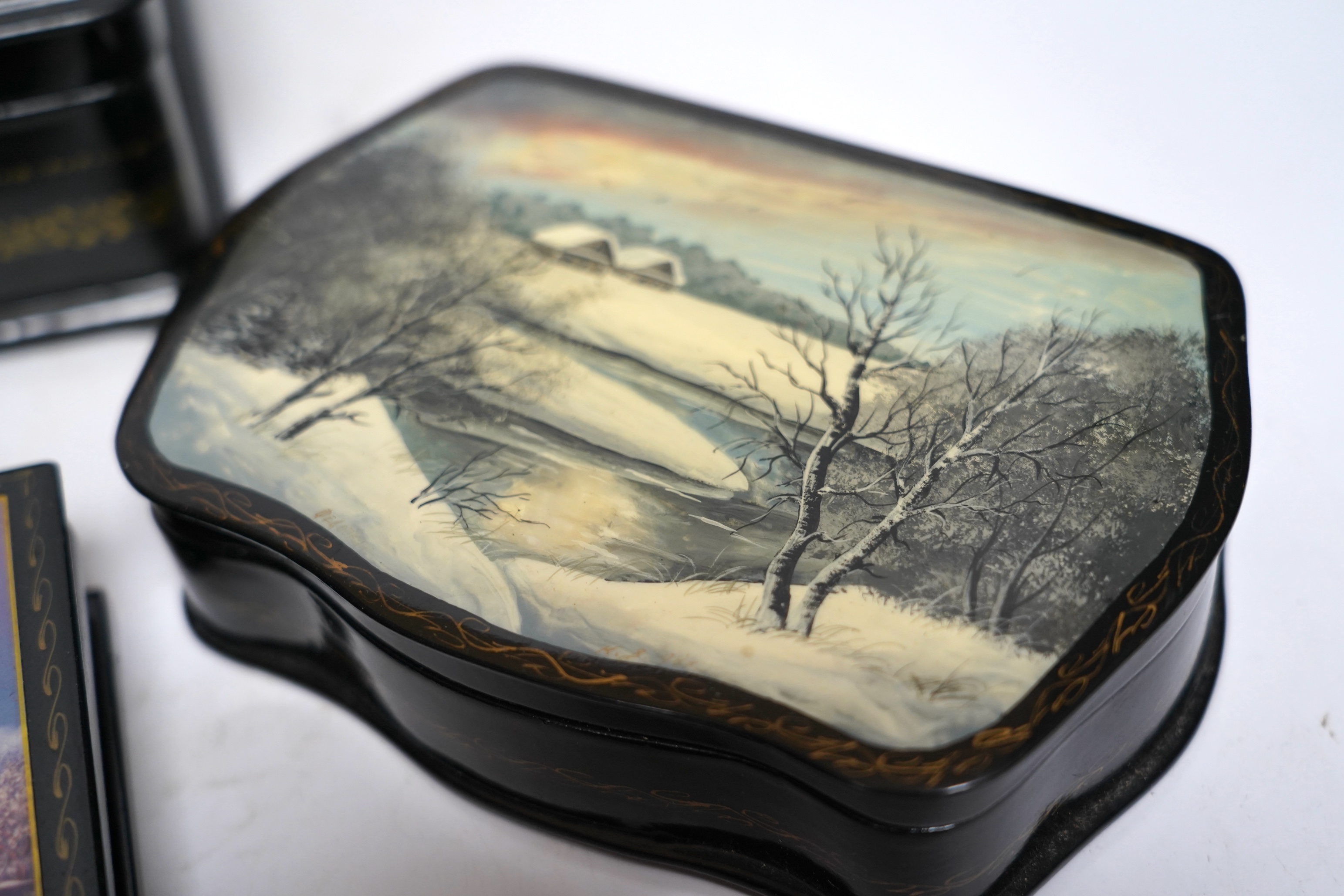 Seven Russian lacquer boxes, largest 21.5cm wide. Condition - fair to good